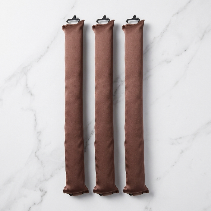 Three Olla Bella Jumbo Heatless Curler Rods arranged vertically on a white marble surface.