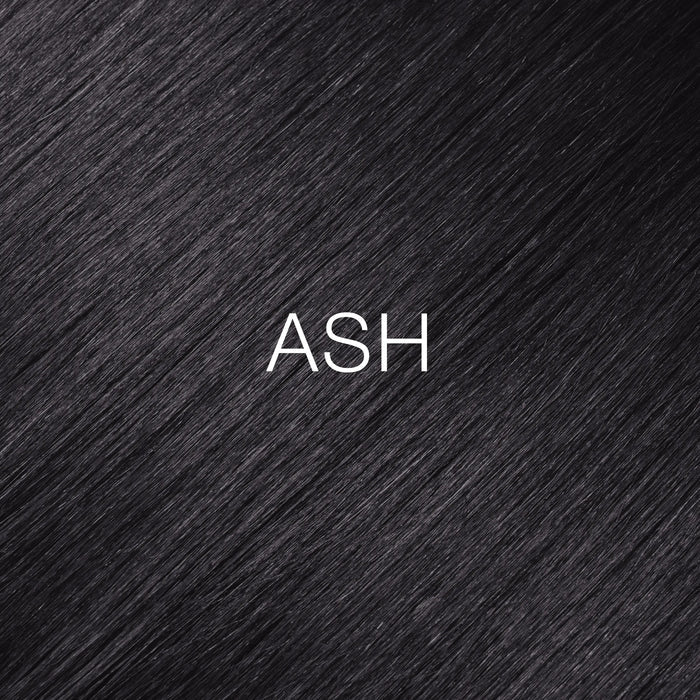 GK Hair Juvexin Cream Color Mixtones Ash: near-black hair close-up with a cool gray cast, ASH printed across the strands