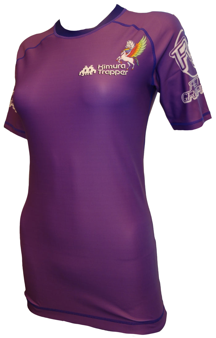 The Kimura Trapper Purple Pegasus Rash Guard by Retro Grappler features short sleeves, a fitted purple design with white graphics—including a pegasus and Kimura Trapper text—perfect for jiu jitsu rash guard fans.