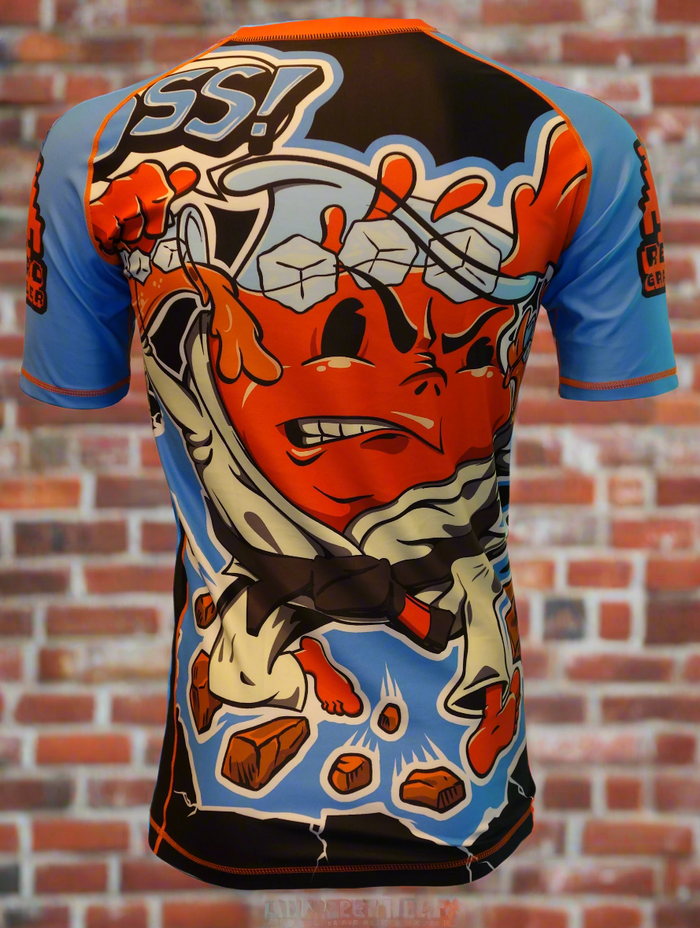 The Retro Grappler Kool-Cult Rashguard Kool Aid Parody features a vibrant cartoon pitcher as a martial artist smashing boards, “OSS!” in bold, and is crafted from four-way stretch fabric—a limited-edition must for jiu-jitsu fans.