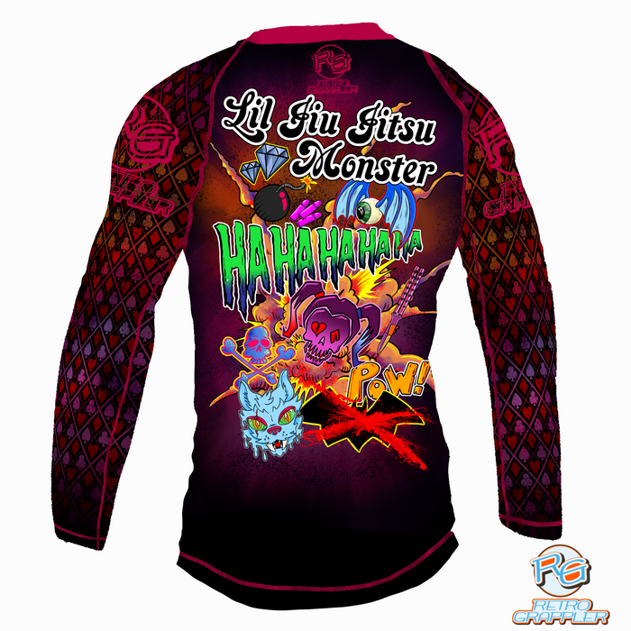 The Lil Jiu Jitsu Monster Rash Guard by Retro Grappler features bold cartoon graphics, “Lil Jiu Jitsu Monster” text, “HAHAHAHA” on the back, four-way stretch polyester-spandex, and UPF 38-40 sun protection for active kids.