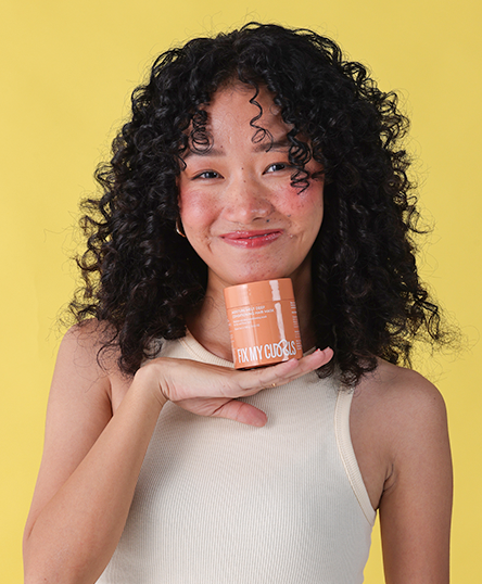 The model is captured showcasing Fix My Curls’ Moisture Melt Deep Conditioning Hair Mask