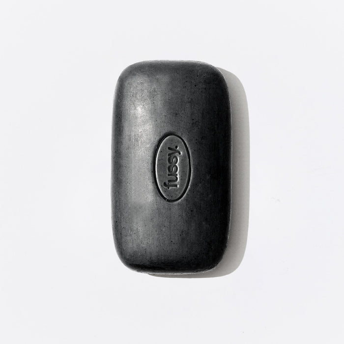 One singular, black, natural exfoliating bar from Fussy.