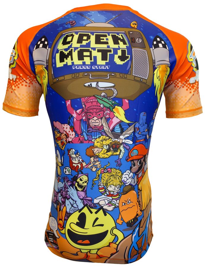 The Retro Grappler Orlando Open Mat Rash Guard showcases pixel art graphics—featuring a retro TV with ULTIMATE OPEN MAT SESSION, rockets, spaceships, and pop culture icons like Pac-Man and Mario on an orange and blue backdrop.