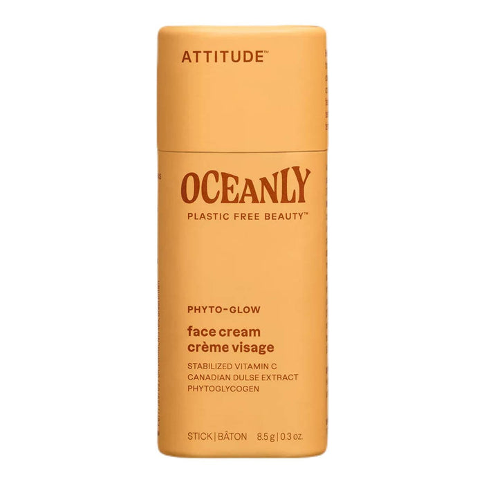 Orange face cream stick with 'Attitude' branding on a white background.