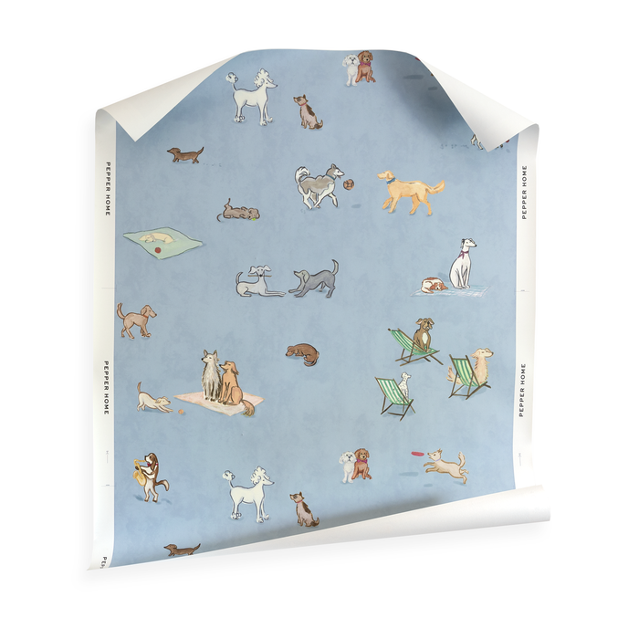 Pippa Powder wallpaper with whimsical dog illustrations playing and relaxing on a soft blue background with green striped chairs