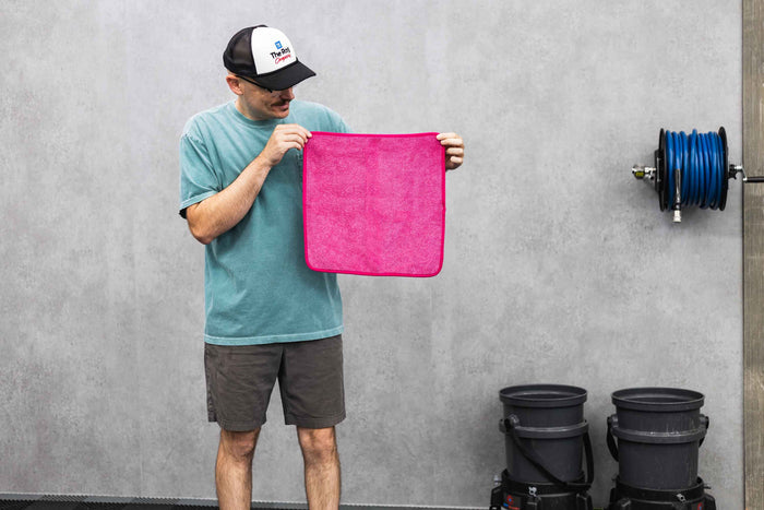 Person holding a pink FTW microfiber.