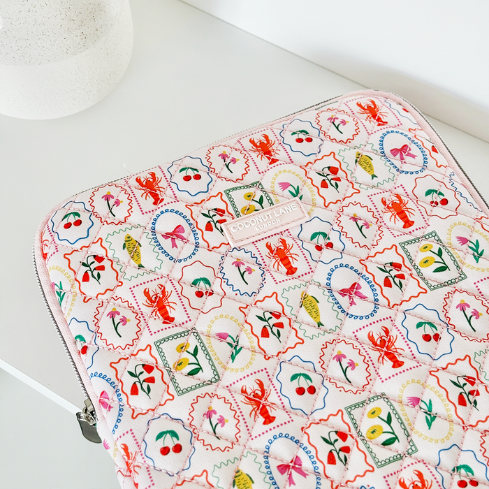 Quilted iPad sleeve with colorful animal and plant patterns, designed by Coconut Lane.
