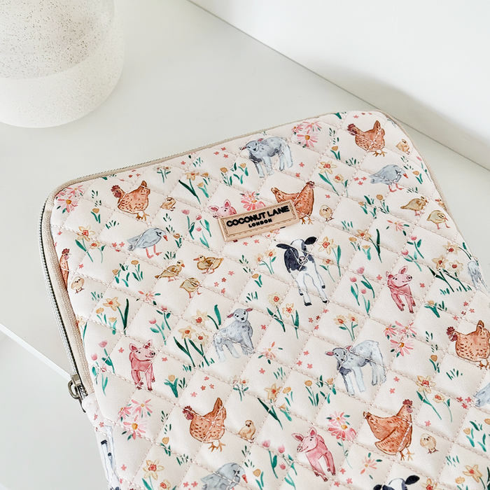 Quilted iPad sleeve with colorful farm animal pattern on a light background, designed by Coconut Lane.