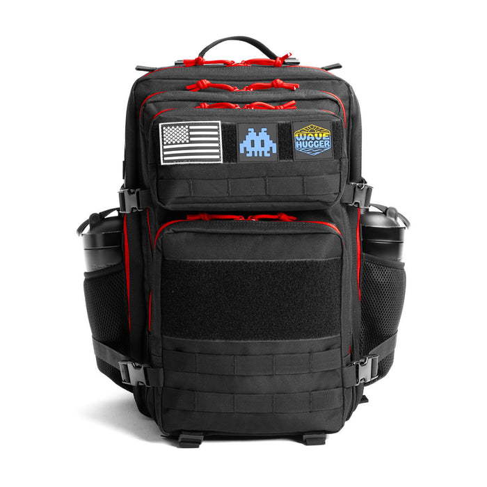 Black tactical backpack with red accents and patches on a white background