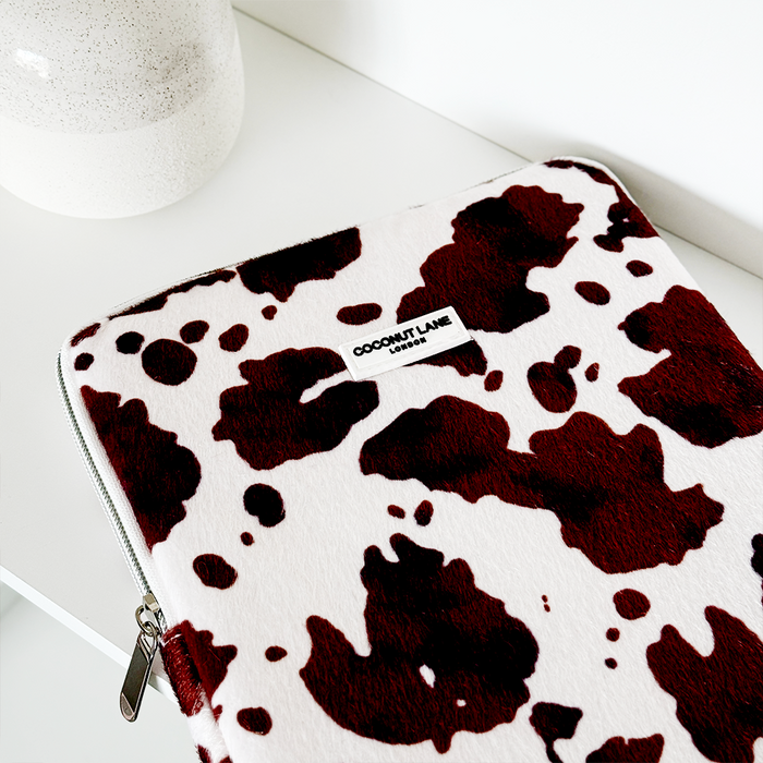 Pink Rodeo Cowgirl iPad sleeve by Coconut Lane on a white surface beside a small speckled white vase.