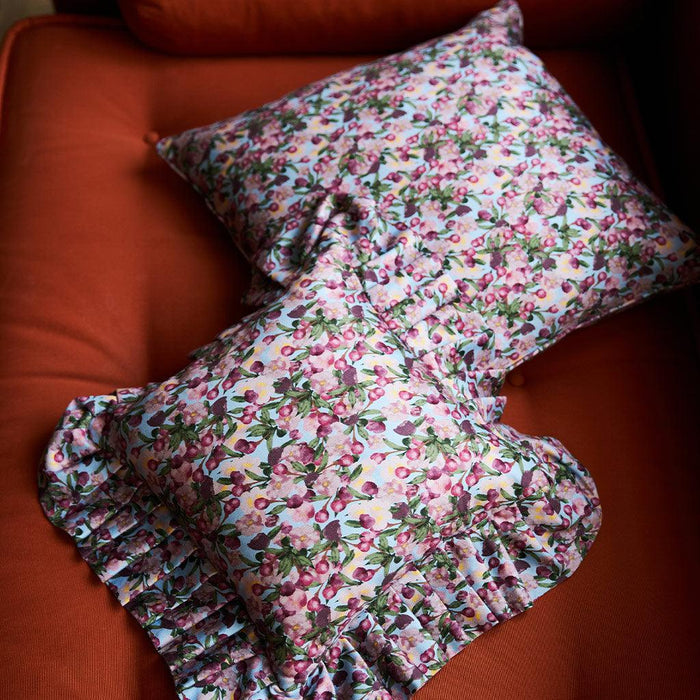 Close-up of the Romance Is Dead Organic Cotton Ruffled Pillow Cover in Blue print
