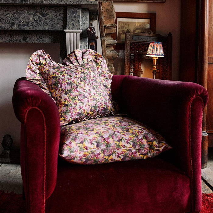 Styled view of the Romance Is Dead Organic Cotton Square Pillow Cover in Yellow