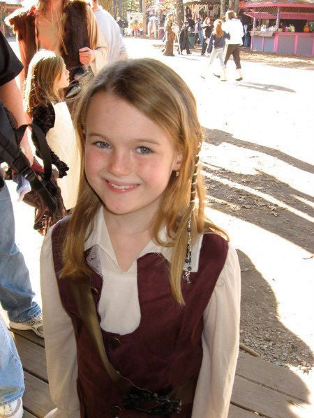 Young girl wearing multiple Silver 4-Inch Spiral Hair Twisters with Charms at Renaissance fair