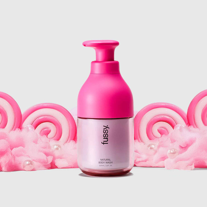 Fussy's Sugar Crush Body Wash Starter pack with Hot Pink refillable bottle set against a backdrop of pink cotton candy.