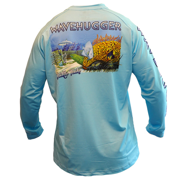 The Wave Hugger Tattle Tails Performance Shirt is light blue, features an underwater reef with coral, fish, a turtle, and Turtle Tails text on the back. Made from moisture-wicking fabric, it offers UPF 50+ sun protection.