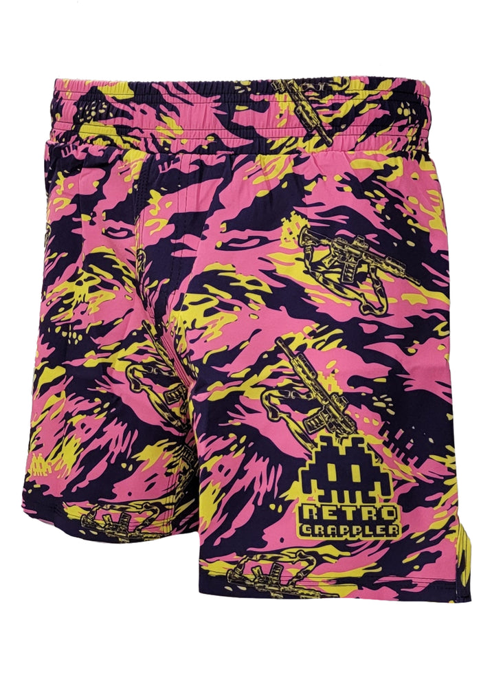 The Thai Tiger Stripe Camo Grappling Shorts by Retro Grappler feature pink, yellow, and black camo with pixelated space invaders and grapplers plus logo/text on one leg. Designed without Velcro for ultimate comfort.