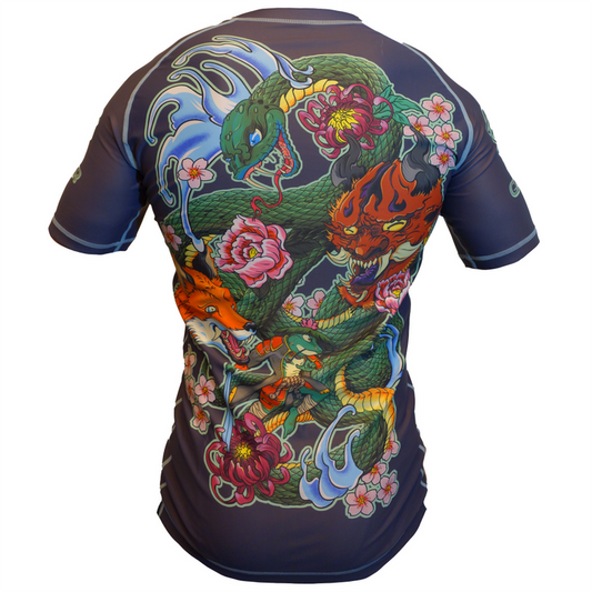 The Retro Grappler The Frog and the Snake Japanese BJJ Rash Guard is a short-sleeved black shirt featuring vibrant Irezumi-style artwork with a green dragon, orange fox, flames, flowers, and waves on the back in bold Japanese tattoo style.