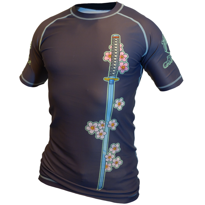 The Frog and the Snake Japanese BJJ Rash Guard by Retro Grappler: a dark short-sleeved athletic shirt inspired by Japanese tattoo art, with a vertical katana, pink cherry blossoms, and light seam stitching for that authentic Retro Grappler vibe.