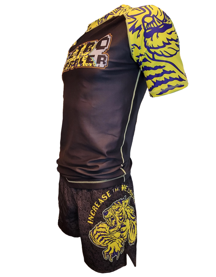 The Retro Grappler Tiger Pressure Grappling Shorts are lightweight BJJ shorts in black and yellow, featuring bold tiger graphics and INCREASE THE HEAT printed on the left leg.