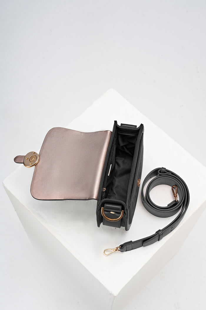 Overhead shot of the inside of Venetia Black Faux leather Saddle Crossbody with detached crossbody strap