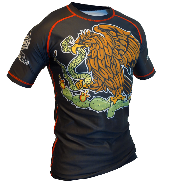 The Viva La Raza Mexico BJJ Rash Guard by Retro Grappler is a black, short-sleeve athletic shirt with red trim and an eagle-and-snake-on-cactus graphic—ideal for jiu jitsu and combat sports.