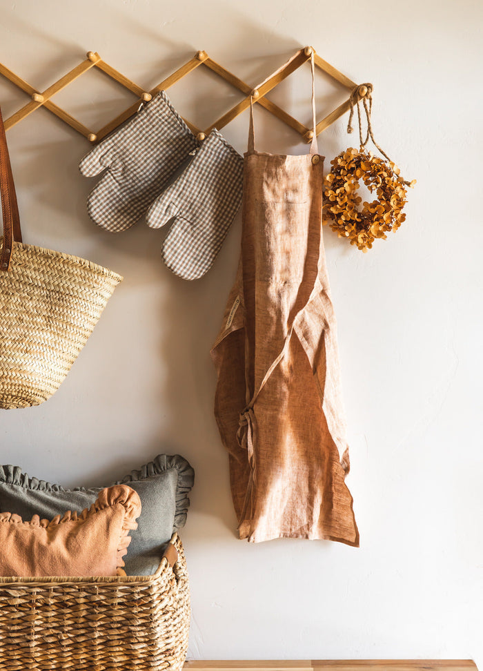 Washed Linen Apron — apron hanging from a wall rack; Farmhouse Pottery