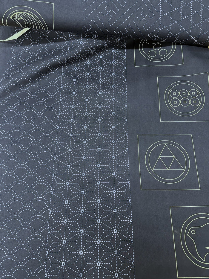 Roll of dark fabric with white sashiko patterns