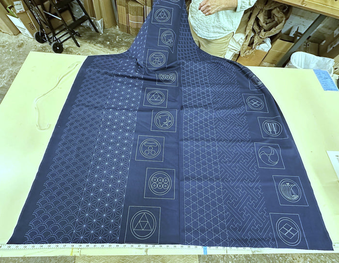 Blue fabric with geometric patterns on a light green surface