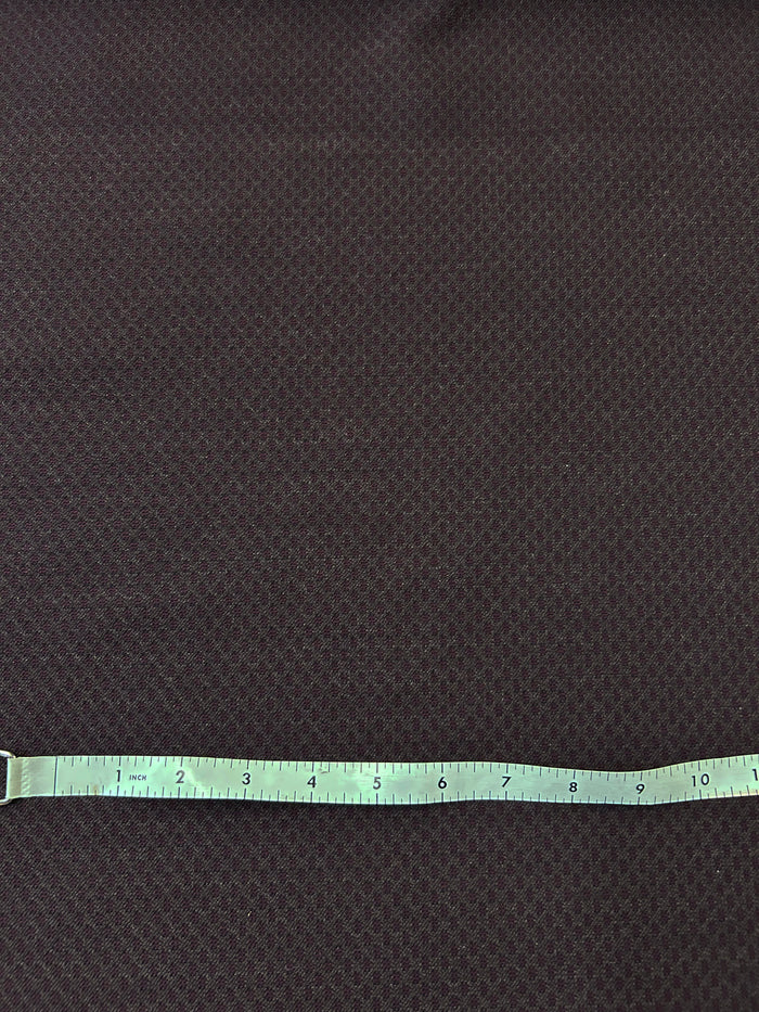 This fabric has a somewhat of a texture re created by the jacquard weave. This fabric print resembles a art deco retro era. dark reds and browns. With a white measuring tape on top.