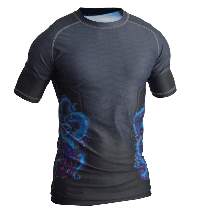 The Retro Grappler Wrapped Up Jiu Jitsu Rash Guard is a dark gray short-sleeve athletic shirt with blue and purple octopus accents at the waist, made of soft four-way stretch fabric featuring a textured pattern on a white backdrop.