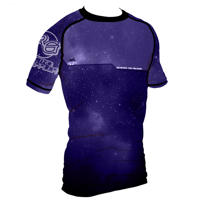 The Retro Grappler Youth - Galaxy Increase the Pressure Rash Guard features short sleeves, a dark blue and purple galaxy print with white stars, black trim, and INCREASE THE PRESSURE printed on the chest for comfort and style.
