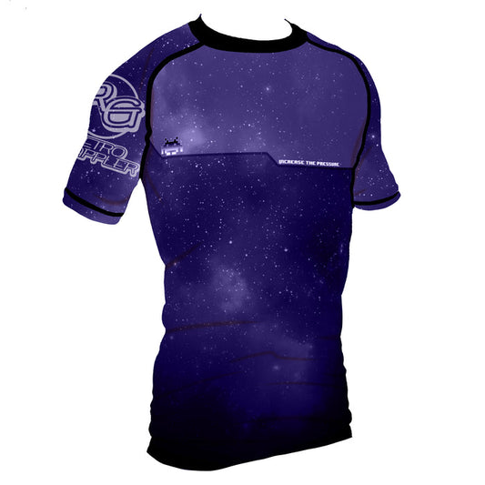 The Retro Grappler Youth - Galaxy Increase the Pressure Rash Guard features short sleeves, a dark blue and purple galaxy print with white stars, black trim, and INCREASE THE PRESSURE printed on the chest for comfort and style.