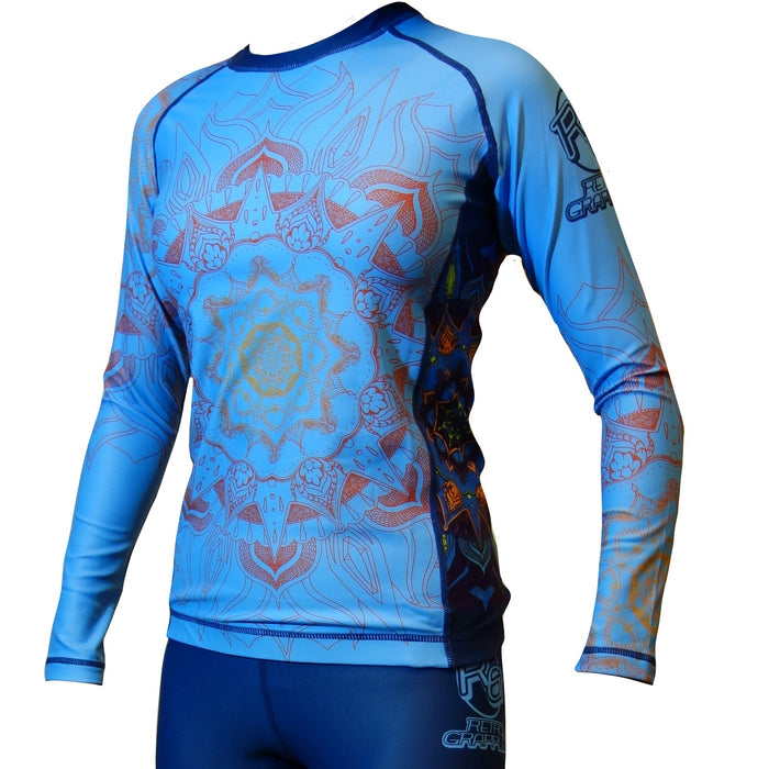 A person wears the Retro Grappler Youth - Zen Line: Mandala Rash Guard—bright blue, long-sleeve, with mandala patterns and four-way stretch fabric—paired with matching spats for a stylish, comfortable fit.